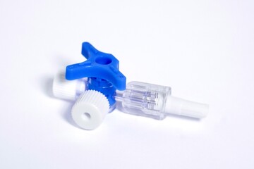 IV Injection connector object with blue switch valve isolated on horizontal white background.