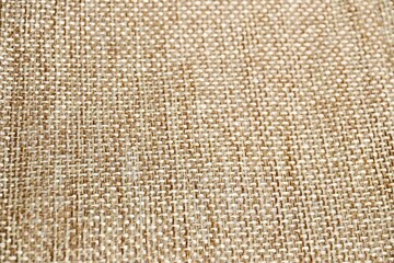 Close up brown rough woven canvas texture isolated on horizontal full frame background.
