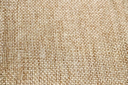 Close up brown rough woven canvas texture isolated on horizontal full frame background.