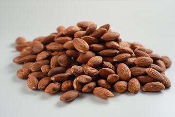 Heap of almonds isolated on white background. Perfect for recipes, articles or any cooking content