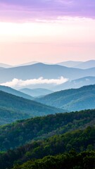 Obraz premium Layered mountain ranges with misty valleys, bathed in soft pastel hues of sunrise and sunset.
