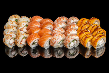 Assorted sushi rolls with salmon, shrimp, cheese, and mango sauce on black background