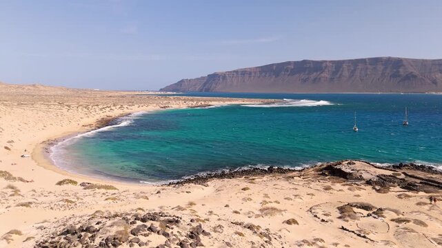 Aerial Drone Shot Flying Over Playa Francesa Beach And La Graciosa Island In The Canary Islands, Spain On A Bright Day.