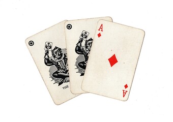 A hand of vintage playing cards showing a pair of jokers and one other card on a white background.