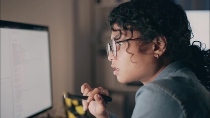 Close-up of female programmer in eyeglasses working late, focusing on coding and cybersecurity for artificial intelligence, symbolizing technology, network security, and innovation. - Powered by Adobe