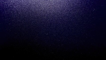 deep shimmering violet glitter dust texture with sparkling light reflection for elegant background...