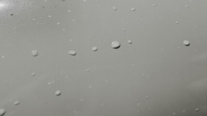 soft gray surface with scattered water droplets closeup texture for modern background or clean design element