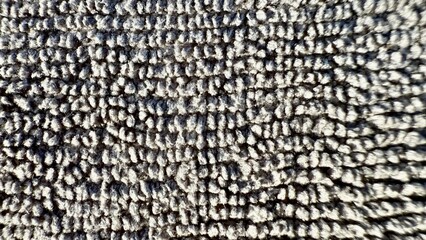 soft gray loop pile carpet texture closeup with geometric woven pattern perfect for modern background or interior design detail