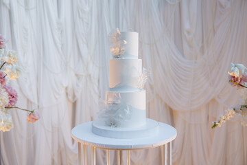 Elegant white wedding cake adorned with delicate floral accents at a dreamy celebration setting
