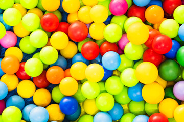 A sea of colorful plastic balls fills a childrens play area inviting kids to jump in and enjoy the vibrant atmosphere Sunlight enhances the playful setting creating joy