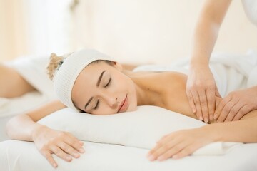 Woman enjoying relaxing massage therapy in spa for stress relief and wellness. Ideal image for self-care and burnout recovery.