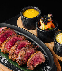 Tender grilled steak served with vibrant side dishes on a platter
