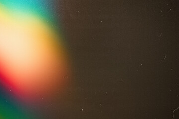 light leak overlay effect with scratch dust and rainbow light leaks,retro noisy film texture light leak flare on black background,grunge film burn texture with light leaks,old film strip