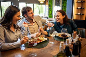 Colleagues Having Fun Sharing Lunch at Restaurant