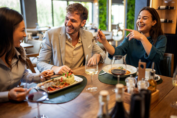 Colleagues Enjoy Lunch with Food and Wine at Restaurant