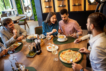 Colleagues Having Fun Sharing Lunch at Restaurant