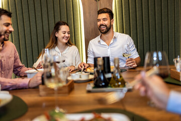 Colleagues Enjoy Lunch with Food and Wine at Restaurant