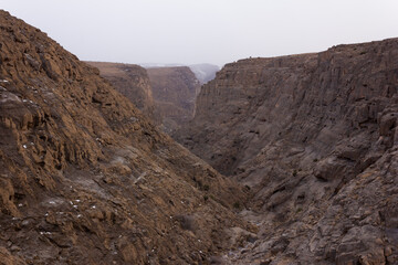 Rugged rocky canyon landscape near Taft, Iran, showcasing dramatic cliffs, geological formations, and natural beauty in a dry mountainous environment.