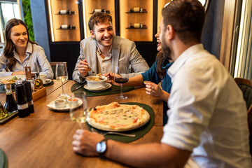 Colleagues Enjoying Lunch with Food and Wine at Restaurant