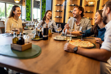 Colleagues Enjoying Lunch with Food and Wine at Restaurant