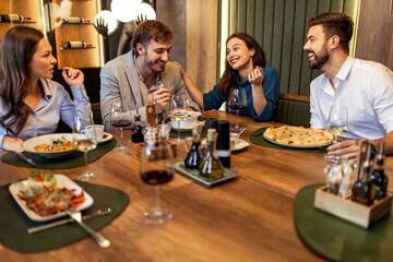 Colleagues Enjoying Lunch with Food and Wine at Restaurant