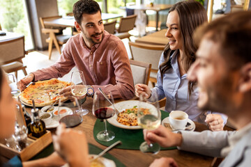 Colleagues Enjoying Lunch with Food and Wine at Restaurant