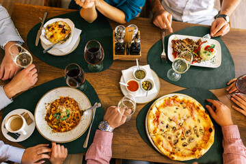 Top View of Hands Eating Lunch with Food and Wine at Restaurant