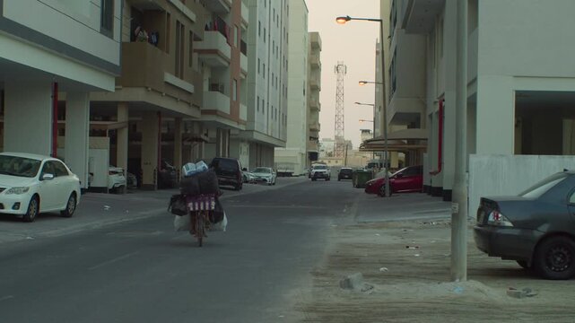 Man bikes past rundown apartment buildings