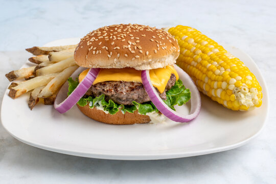 cheese burger with  fries and corn