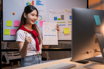 Asian businesswoman showing positive financial report during video call meeting