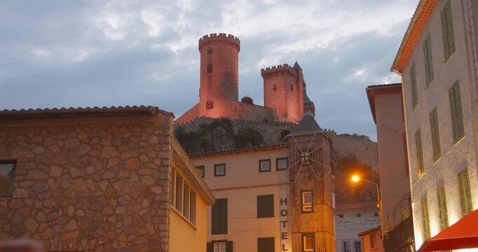 Night View Of Foix Castle In Place du Palais de Justice In Foix, France. Low Angle Shot