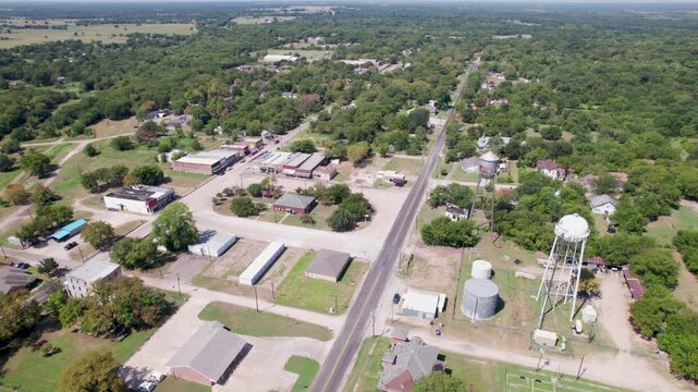 Aerial view of the town of Ladonia, Texas. Camera is flying high above the town and shows the majority of town businesses.