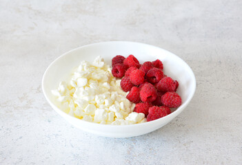 Cottage Cheese and Fresh Raspberries in a White Bowl cut out
