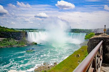 Niagara Falls, Canadian falls, Horseshoe falls close up, white foam and turquoise blue water with Maid of the mist boat