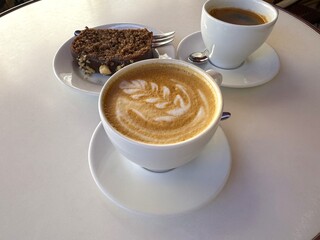 Close-up of cup of coffee and chocolate cake