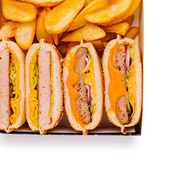 Delicious assortment of hot dogs and golden fries served in a takeout box