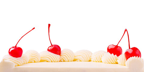 Delicious white cake topped with cherries and whipped cream decoration