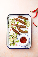 Homemade grilled sausages with cucumber salad