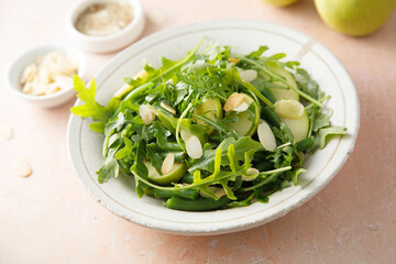 Arugula salad with green apple and almond flakes