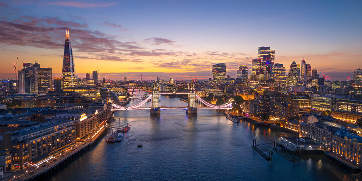 London City Skyline with Tower Bridge Illuminated at Sunset Aerial Panorama, England, United Kingdom