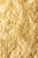 Raw yeast dough close up top view, texture. Making cinnamon rolls. Cinnabon preparation