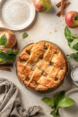 Homemade Apple Pie with fresh apples on textured background top view. Thanksgiving traditional dessert, autumn baking, recipe