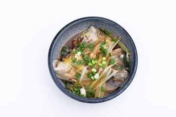 Steamed sea bass in a porcelain bowl