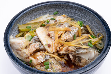 Steamed sea bass in a porcelain bowl