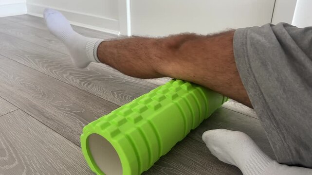 Vertical Footage of Man Using Foam Roller on Leg Muscles &ndash; Self Massage, Myofascial Release, Hamstring and Quadriceps Recovery Exercise