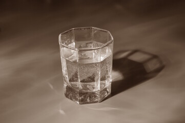 A glass of water on a black and white background.