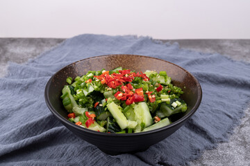A smashed cucumber in a porcelain bowl