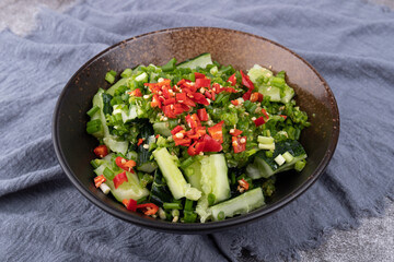 A smashed cucumber in a porcelain bowl