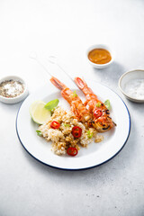 Shrimp skewers with rice and lime