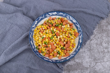 The sausage stir-fried with corn kernels on the plate